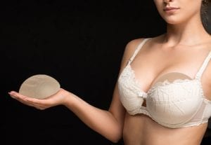 Silicone implants on hand and natural breast
