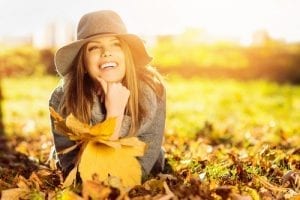 Happy girl enjoying a fall day