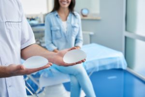 Woman in Doctor's Office Being Shown Breast Implants