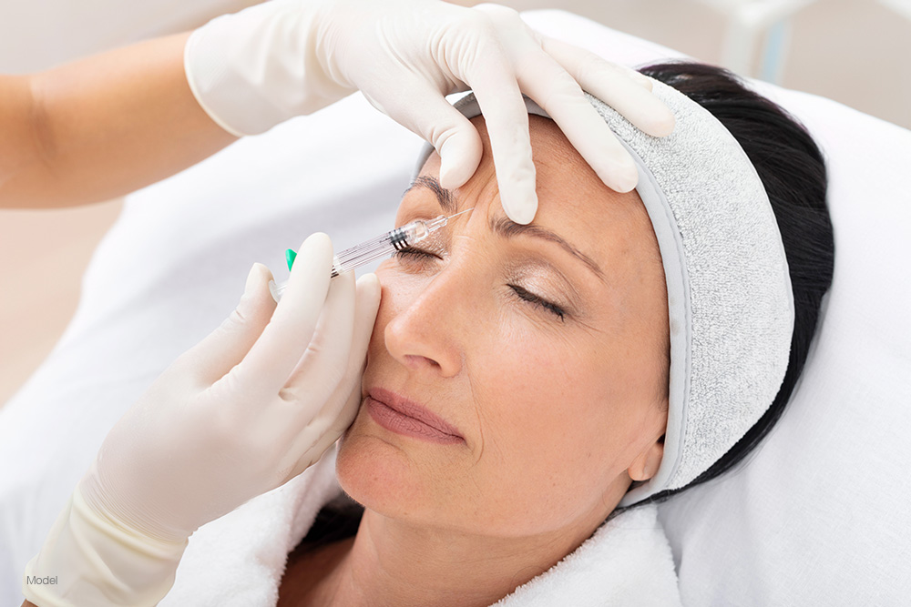Mature woman getting an injection in her forehead 